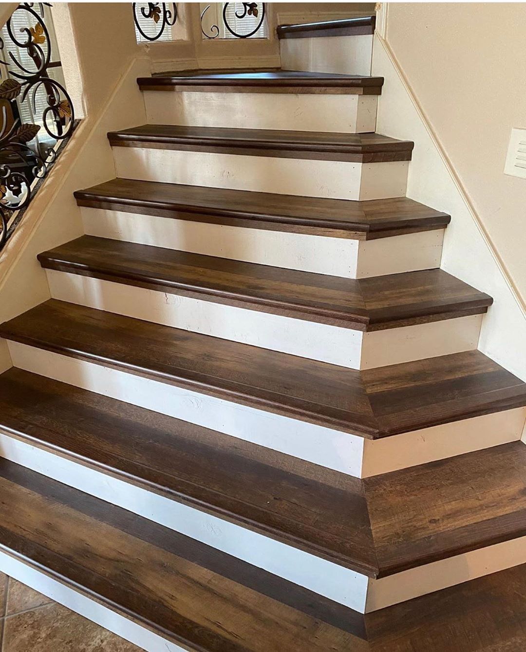 Wide custom staircase with dark wood treads and white risers