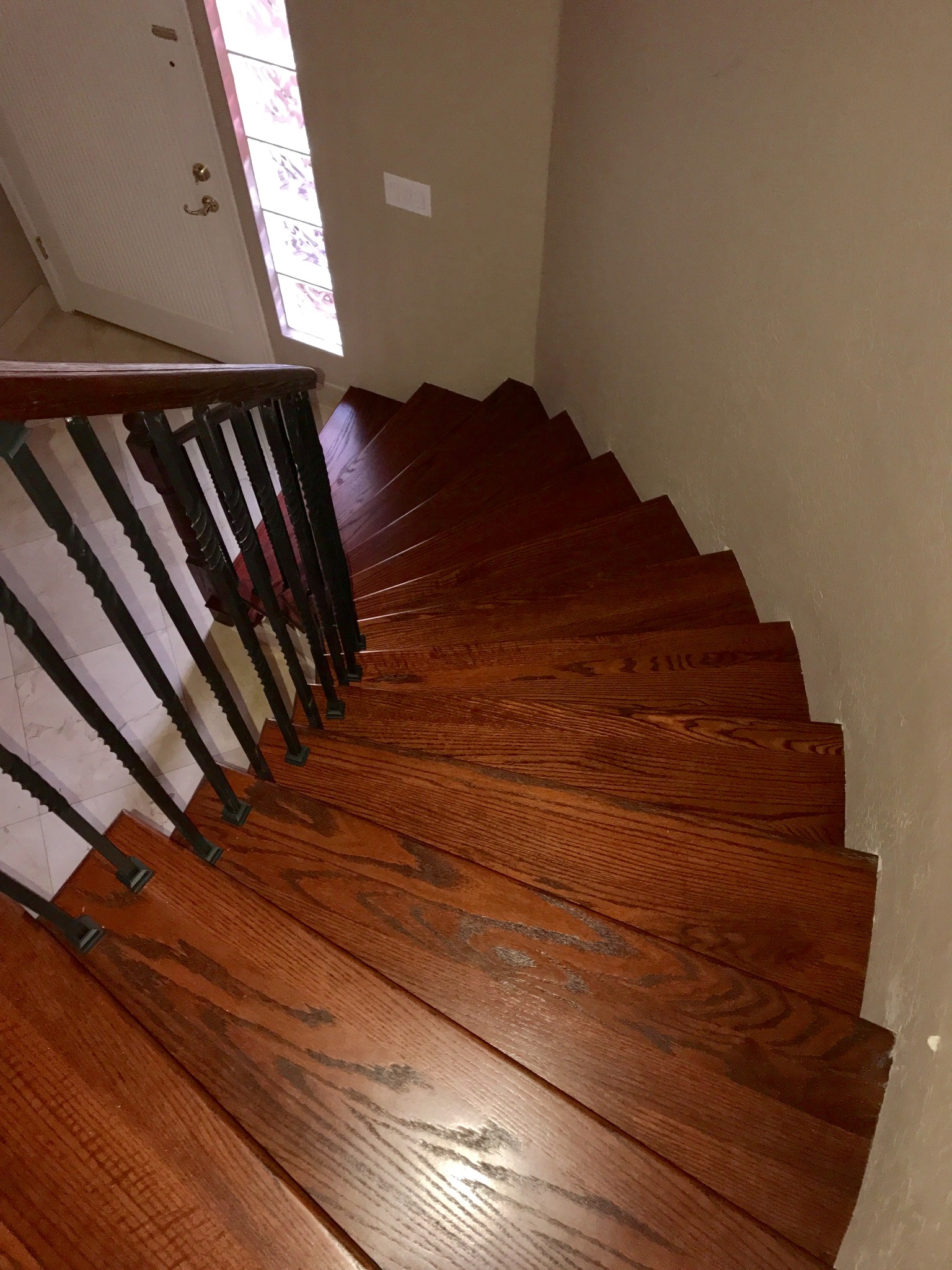 Custom hardwood winder staircase with hand-cut angled treads