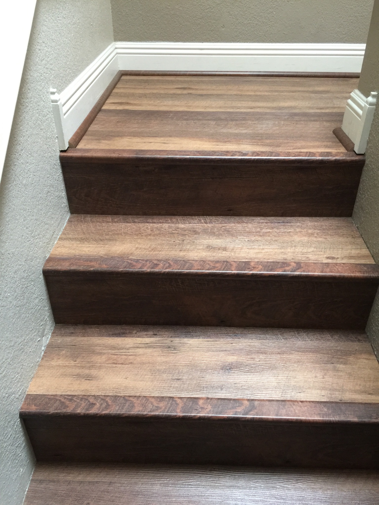 Custom luxury vinyl staircase detail with coordinated nosing and risers