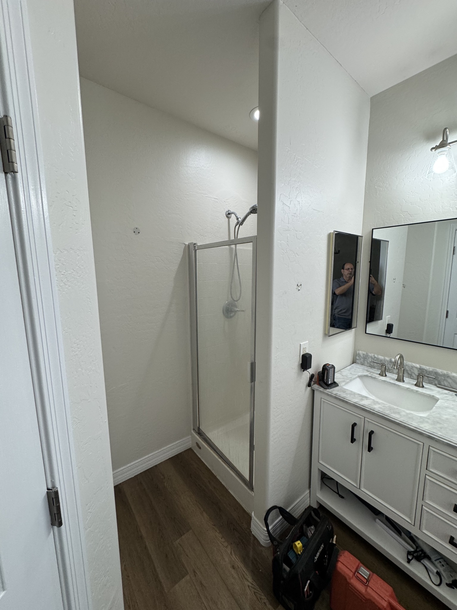 Bathroom shower before remodeling with the original fiberglass enclosure